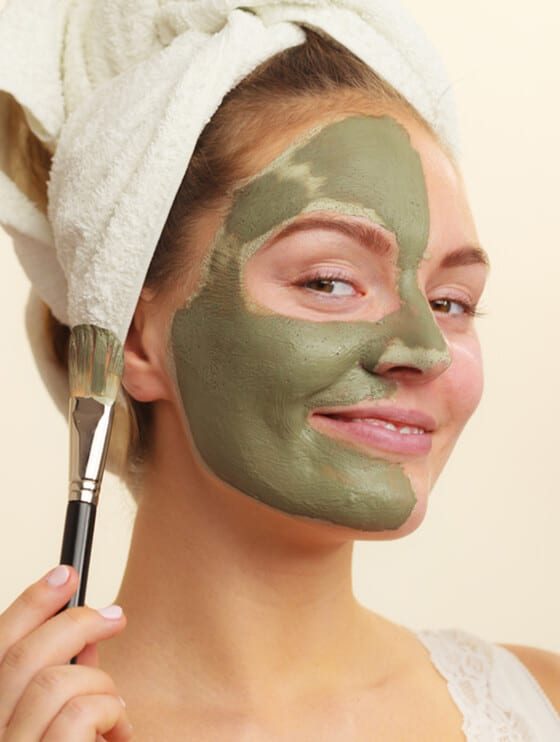 Woman Applying Clay Mask with Brush — Beautician in Coffs Harbour, NSW