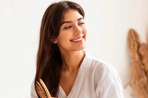 Woman Brushing Her Hair — Beautician in Coffs Harbour, NSW